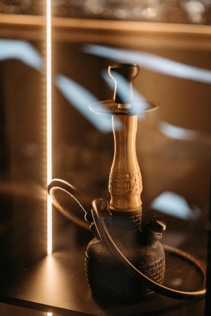 A Hookah Standing on Display behind Glass